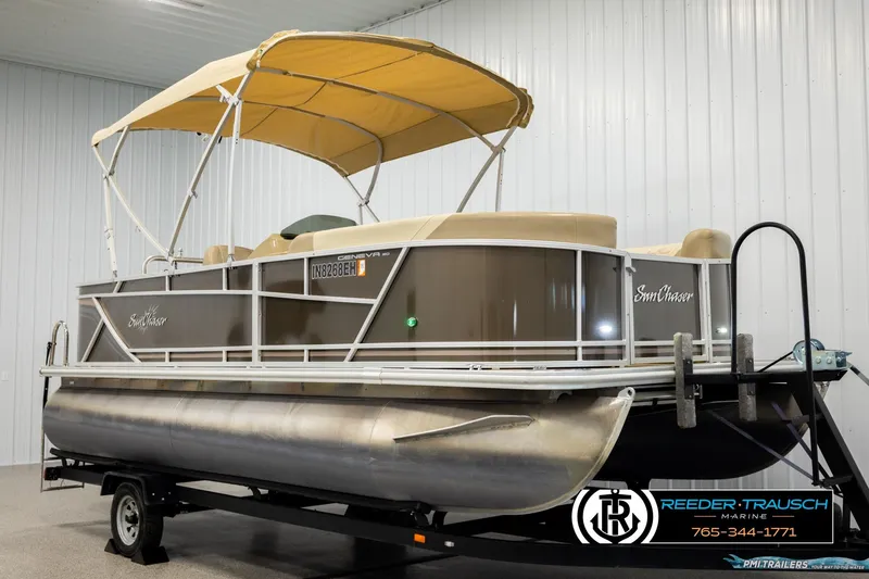 Slide: The Image of 2022 SunChaser 20 Geneva CRS pontoon boat with canopy on trailer in indoor setting. - 3