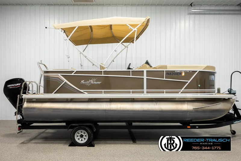 Slide: The Image of 2022 SunChaser 20 Geneva CRS pontoon boat with canopy and Mercury engine in showroom. - 5