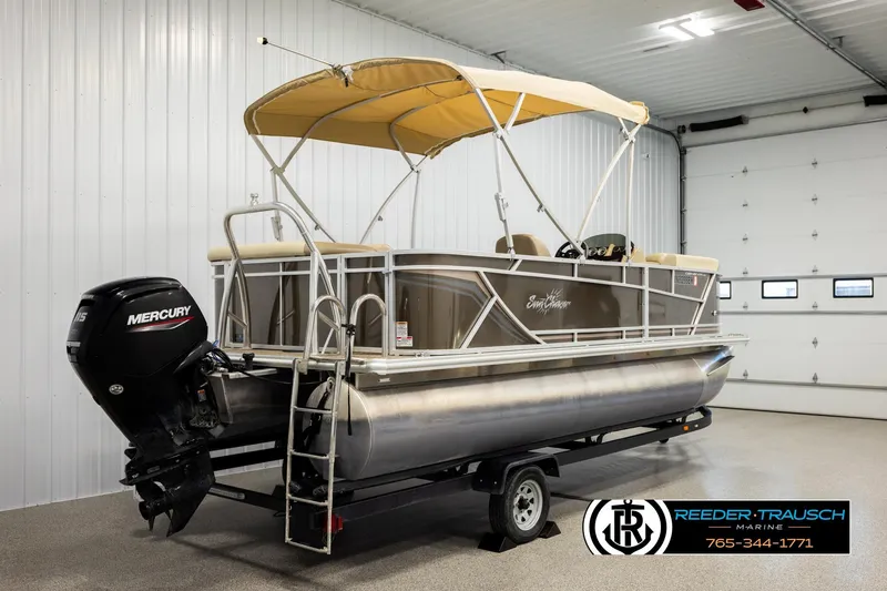 Slide: The Image of 2022 SunChaser 20 Geneva CRS pontoon boat with Mercury engine in indoor showroom. - 6