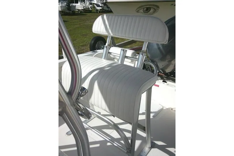 Slide: The Image of 2014 Tidewater 196 CC Adventure boat seat with white upholstery and metal frame. - 13