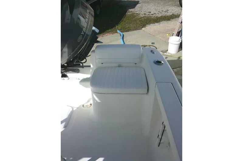 Slide: The Image of 2014 Tidewater 196 CC Adventure boat interior with seating and motor. - 14