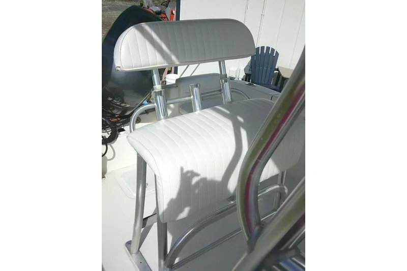 Slide: The Image of 2014 Tidewater 196 CC Adventure boat seat with white upholstery and metal frame. - 19