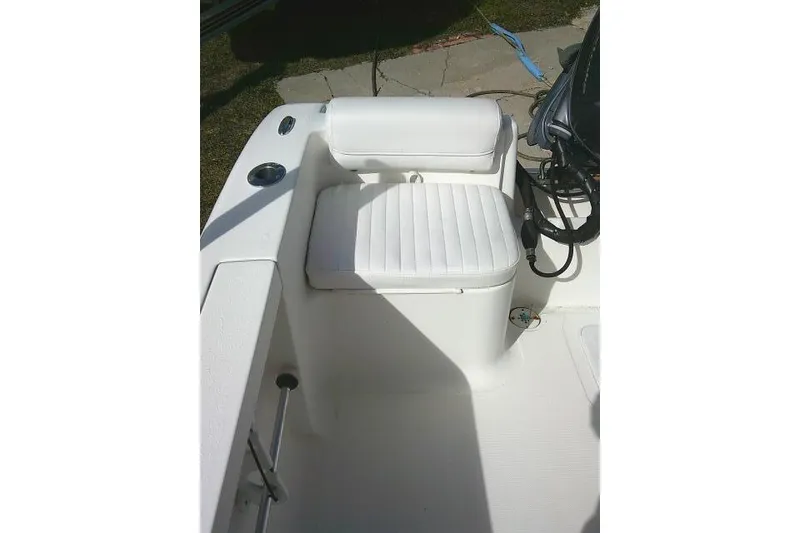 Slide: The Image of 2014 Tidewater 196 CC Adventure boat seat with white upholstery and storage compartment. - 20