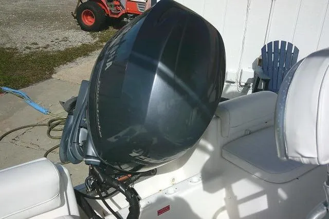 Slide: The Image of 2014 Tidewater 196 CC Adventure boat with Yamaha outboard motor, white seating, and outdoor setting. - 21