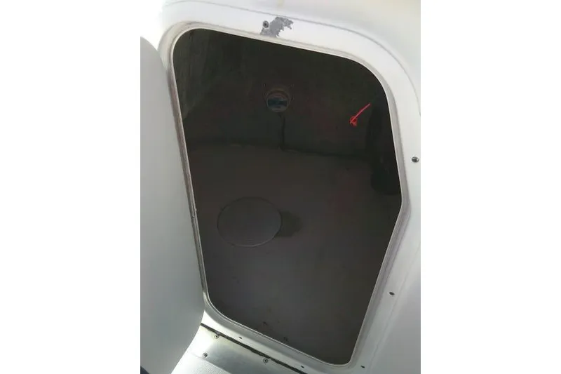 Slide: The Image of Storage compartment of a 2014 Tidewater 196 CC Adventure boat, open and empty. - 24
