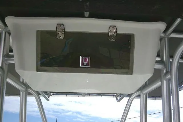 Slide: The Image of 2014 Tidewater 196 CC Adventure boat's overhead storage compartment with metal hinges. - 26