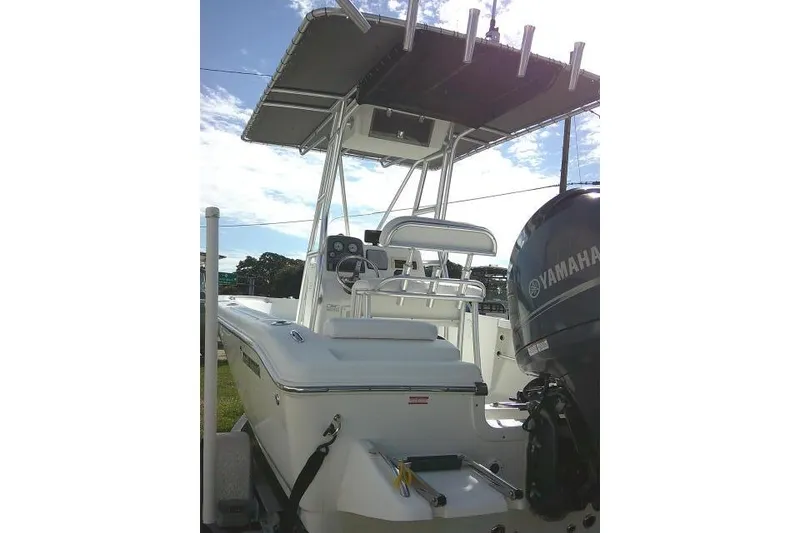 Slide: The Image of 2014 Tidewater 196 CC Adventure boat with Yamaha engine, featuring a T-top and seating. - 28