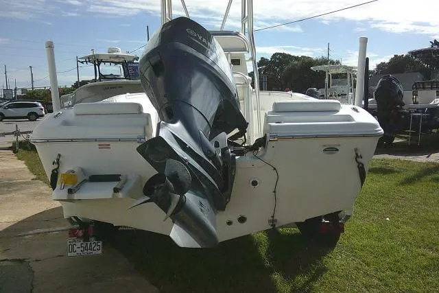 Slide: The Image of 2014 Tidewater 196 CC Adventure boat with outboard motor, parked on grass. - 6