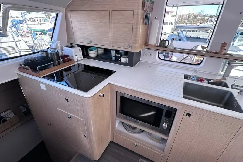 Slide: The Image of Modern kitchen interior of 2021 Outremer 51 yacht with appliances and wooden cabinetry. - 15
