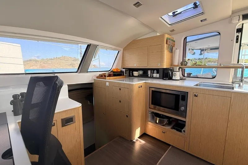 Slide: The Image of Modern kitchen interior of 2021 Outremer 51 catamaran with ocean view. - 16