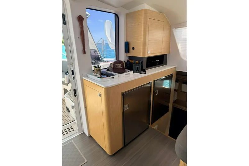 Slide: The Image of Interior of 2021 Outremer 51 yacht, featuring modern kitchen with wooden cabinetry and appliances. - 17