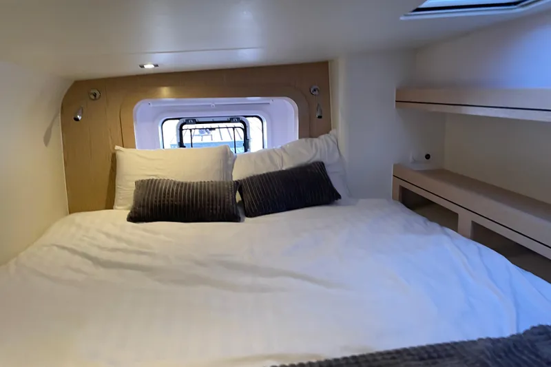 Slide: The Image of Cozy cabin interior of 2021 Outremer 51 yacht with comfortable bedding and window view. - 19