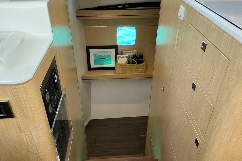 Slide: The Image of Interior of 2021 Outremer 51 yacht with wooden cabinetry and small window. - 21
