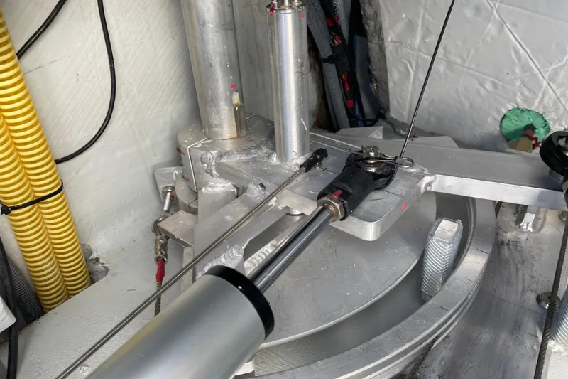 Slide: The Image of Mechanical components inside a 2021 Outremer 51 yacht, featuring hydraulic and metal elements. - 27