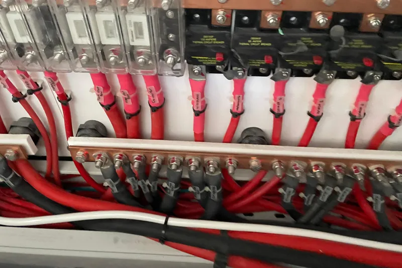 Slide: The Image of Electrical wiring and circuit breakers in a 2021 Outremer 51 yacht. - 28