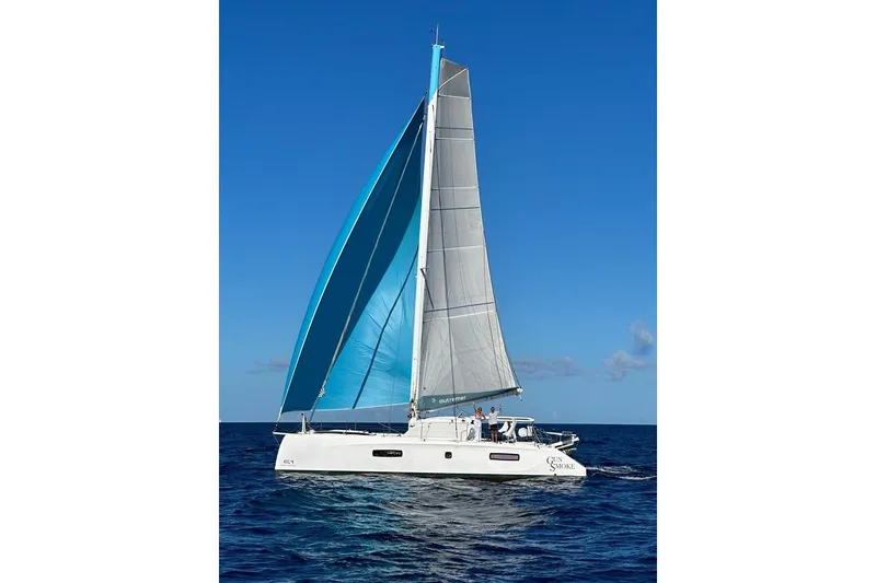 Slide: The Image of 2021 Outremer 51 catamaran sailing on open sea under clear blue sky. - 3