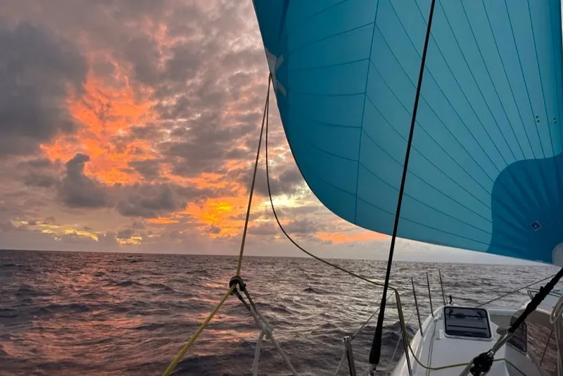 Slide: The Image of Outremer 51 sailing at sunset, vibrant sky and ocean view, 2021 model. - 4