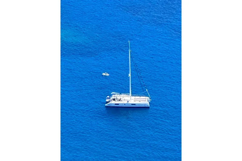 Slide: The Image of 2021 Outremer 51 catamaran sailing on vibrant blue ocean waters. - 5