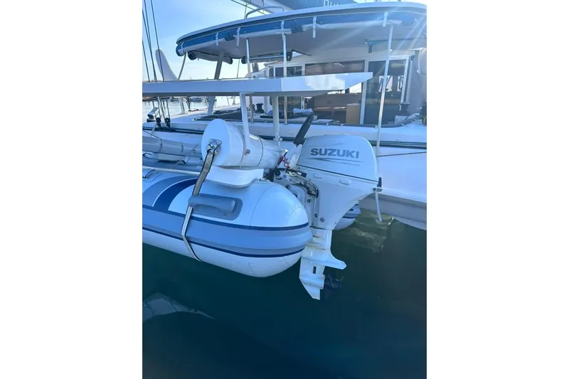 Slide: The Image of Outremer 51 (2021) with Suzuki outboard motor, docked at marina. - 6