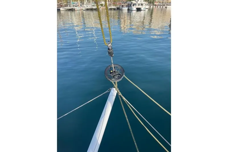 Slide: The Image of Bow of 2021 Outremer 51 catamaran with rigging, docked in calm marina waters. - 9