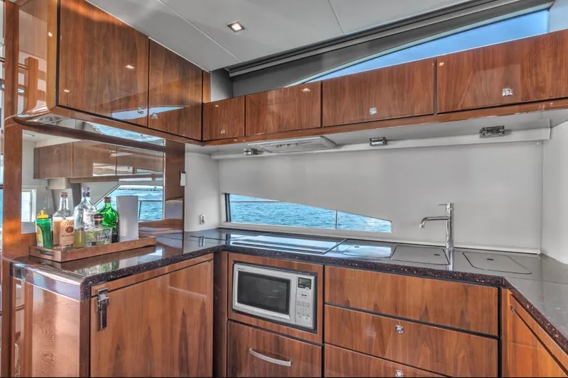 Slide: The Image of Luxurious kitchen interior of 2013 Fairline Squadron 66 yacht with wood cabinetry and ocean view. - 10