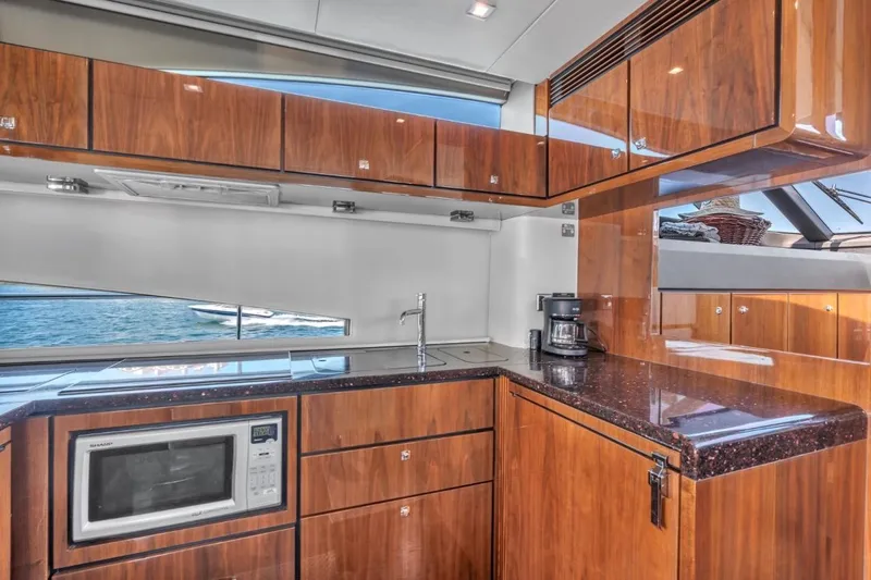 Slide: The Image of Luxurious 2013 Fairline Squadron 66 yacht kitchen with wood cabinetry and modern appliances. - 11