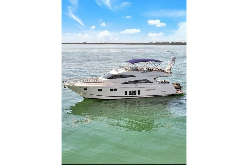 Slide: The Image of 2013 Fairline Squadron 66 yacht on calm water under blue sky. - 4