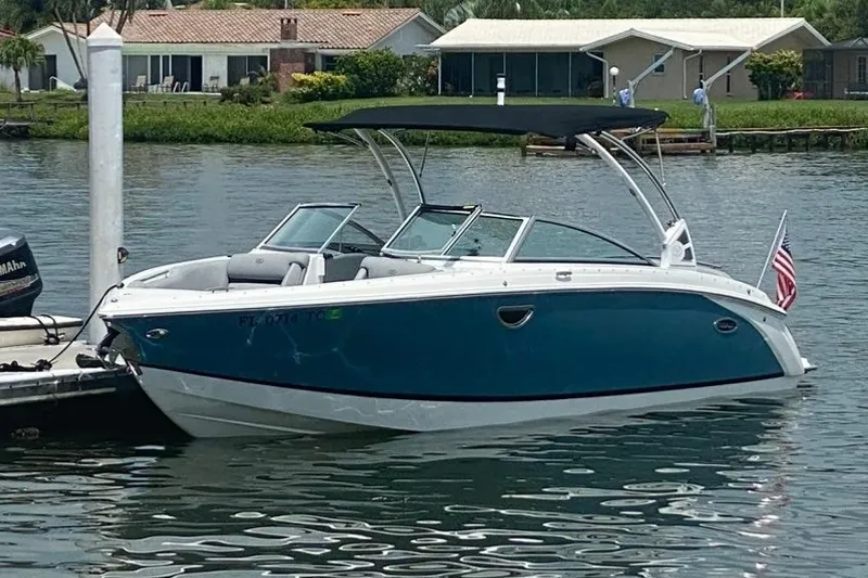The Image of 2021 Cobalt R7 boat docked on a serene waterfront with American flag. - 0