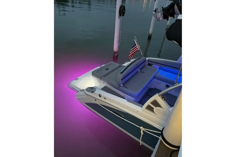 Slide: The Image of 2021 Cobalt R7 boat with purple underwater lights at dock, featuring American flag. - 16