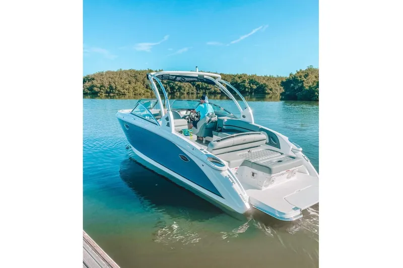 Slide: The Image of 2021 Cobalt R7 boat on calm water with lush green shoreline. - 19