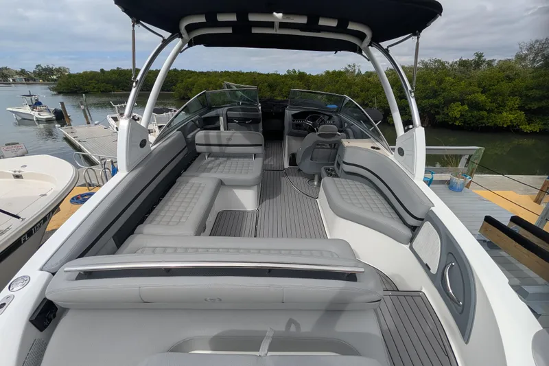 Slide: The Image of 2021 Cobalt R7 boat interior with sleek seating and modern design at a dock. - 4