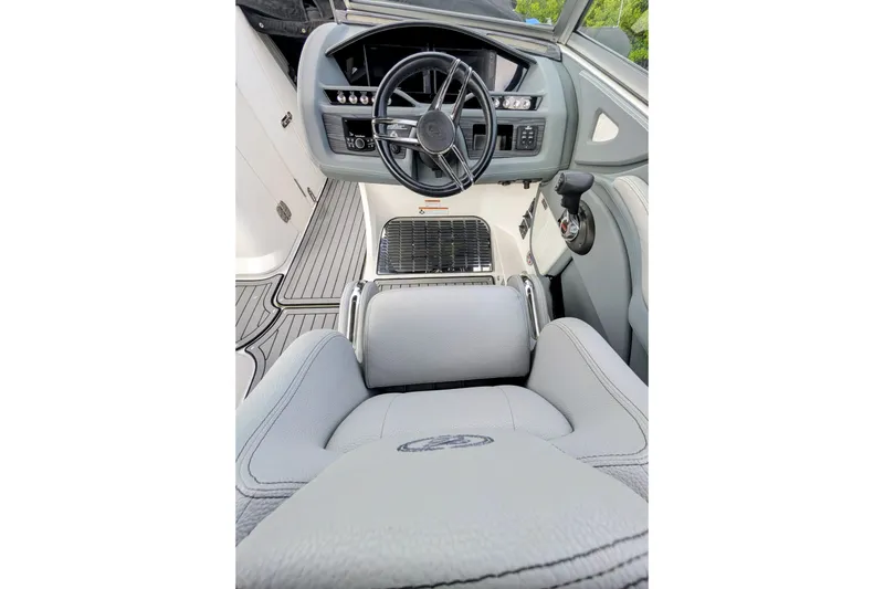 Slide: The Image of Interior of a 2021 Cobalt R7 boat, featuring a sleek steering wheel and modern controls. - 7