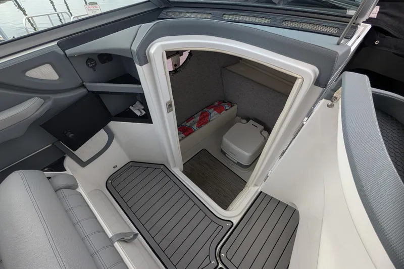 Slide: The Image of 2021 Cobalt R7 boat interior with compact cabin and portable toilet. - 9