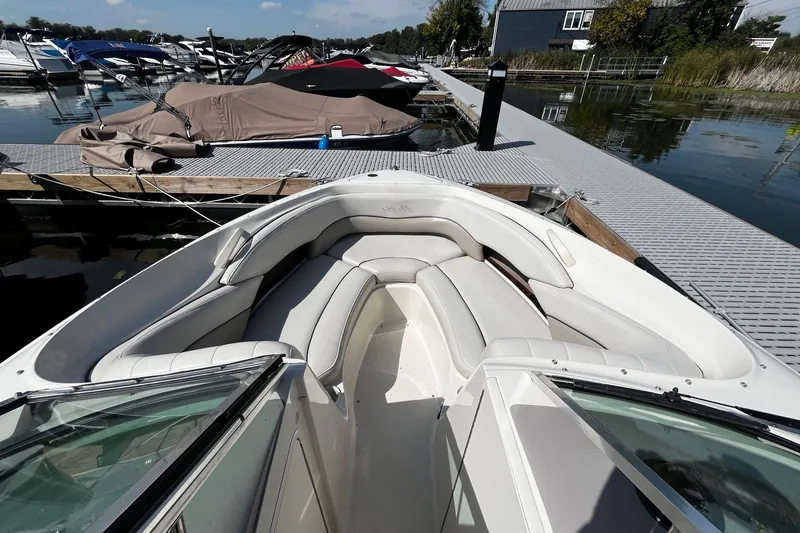 Slide: The Image of 2003 Sea Ray 240 Bow Rider docked at marina, featuring spacious seating and sleek design. - 8