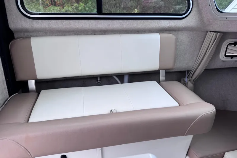 Slide: The Image of Interior seating of 2018 Parker 2120 Sport Cabin boat, featuring beige and white upholstery. - 3