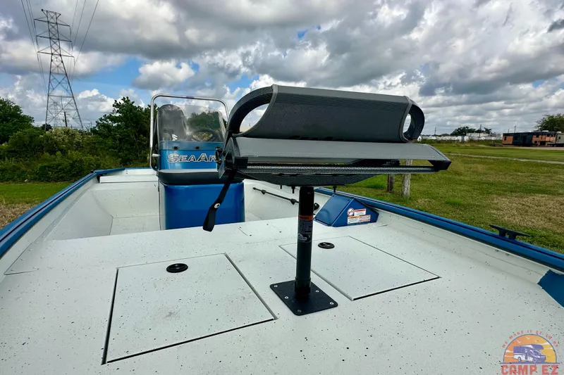 Slide: The Image of SeaArk C1074 Shadow 18TCC boat, 2026 model, with a mounted seat, under cloudy skies. - 11