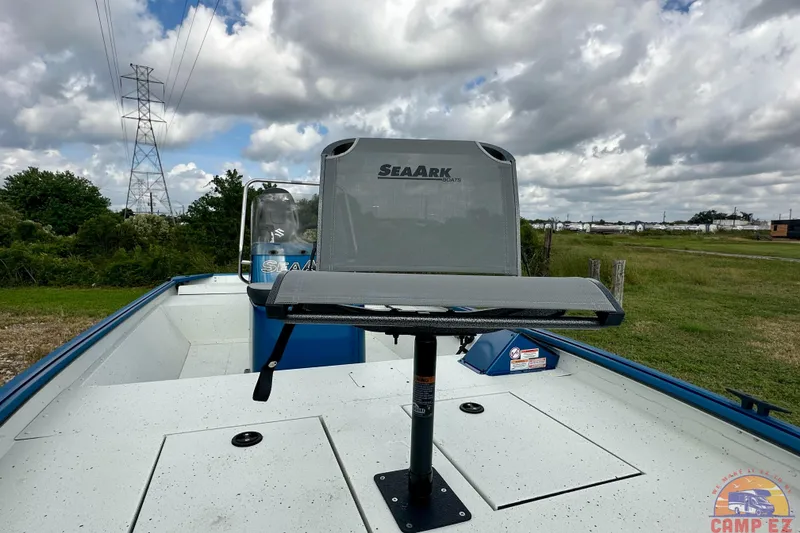 Slide: The Image of 2026 SeaArk C1074 Shadow 18TCC boat with elevated seat, under cloudy sky. - 12