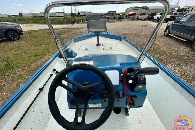 Slide: The Image of 2026 SeaArk C1074 Shadow 18TCC boat interior with steering wheel and controls. - 18