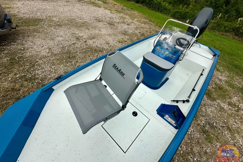 Slide: The Image of 2026 SeaArk C1074 Shadow 18TCC boat with blue accents, featuring seating and steering console. - 22