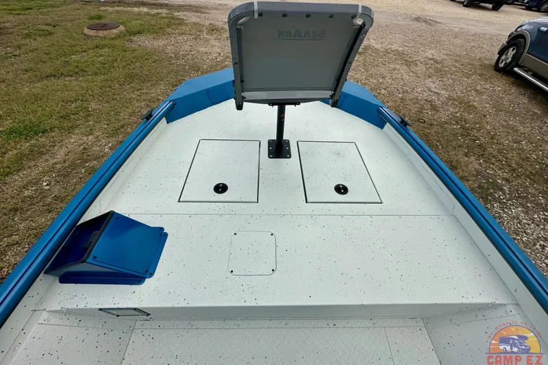 Slide: The Image of 2026 SeaArk C1074 Shadow 18TCC boat interior with storage compartments and open hatch. - 23