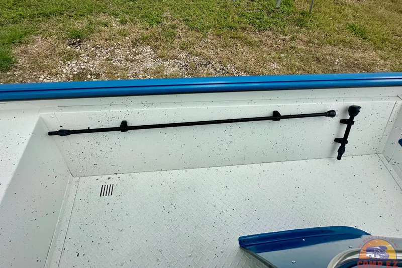 Slide: The Image of 2026 SeaArk C1074 Shadow 18TCC boat interior with rod holder and textured flooring. - 27