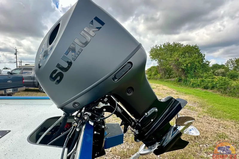 Slide: The Image of Suzuki outboard motor on 2026 SeaArk C1074 Shadow 18TCC boat, parked outdoors. - 6
