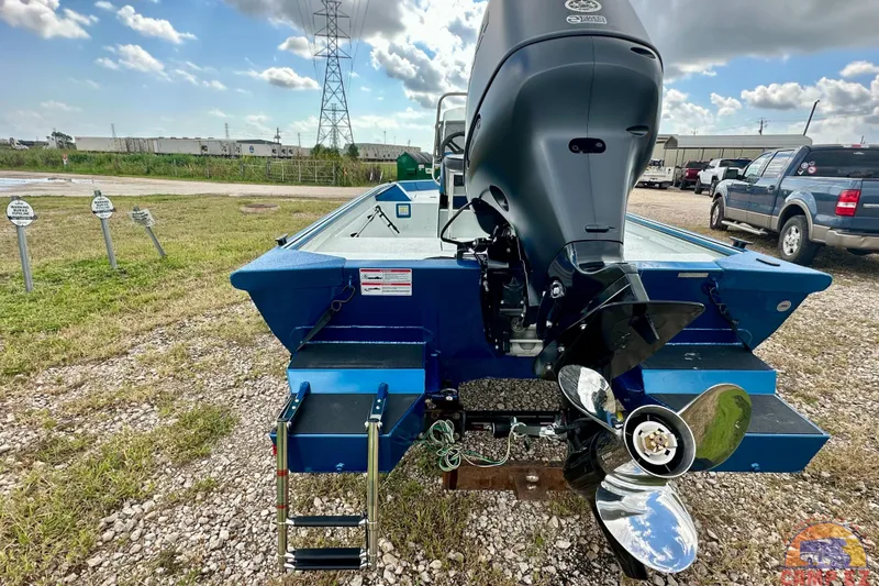 Slide: The Image of 2026 SeaArk C1074 Shadow 18TCC boat with powerful outboard motor, parked outdoors. - 7