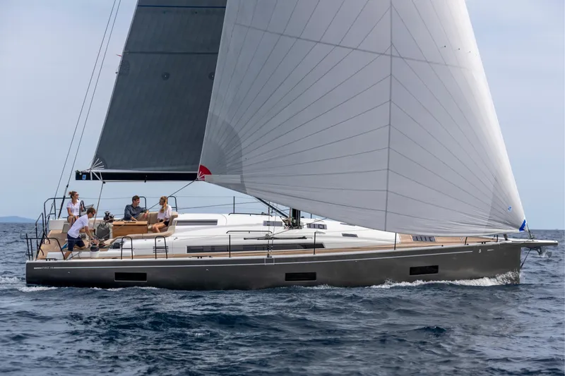 The Image of 2026 Beneteau First 44 sailboat cruising on open water with passengers onboard. - 0
