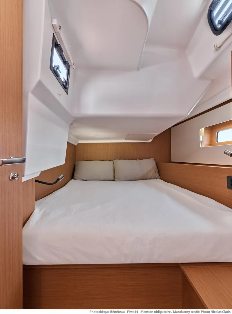 Slide: The Image of Cozy cabin interior of 2025 Beneteau First 44 sailboat with wooden accents. - 10