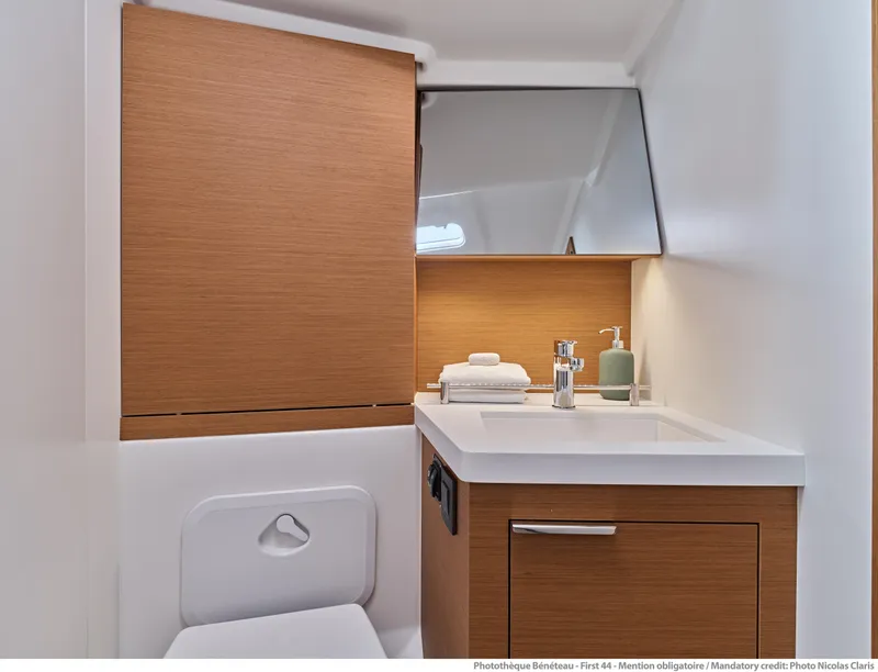 Slide: The Image of Modern bathroom in 2025 Beneteau First 44 yacht with wood accents and sleek design. - 11