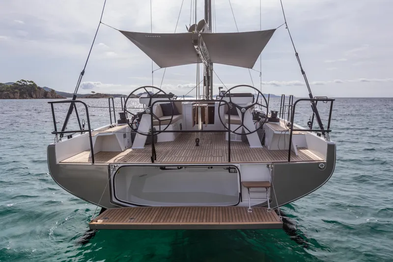 Slide: The Image of 2025 Beneteau First 44 sailboat on calm sea, rear view. - 2