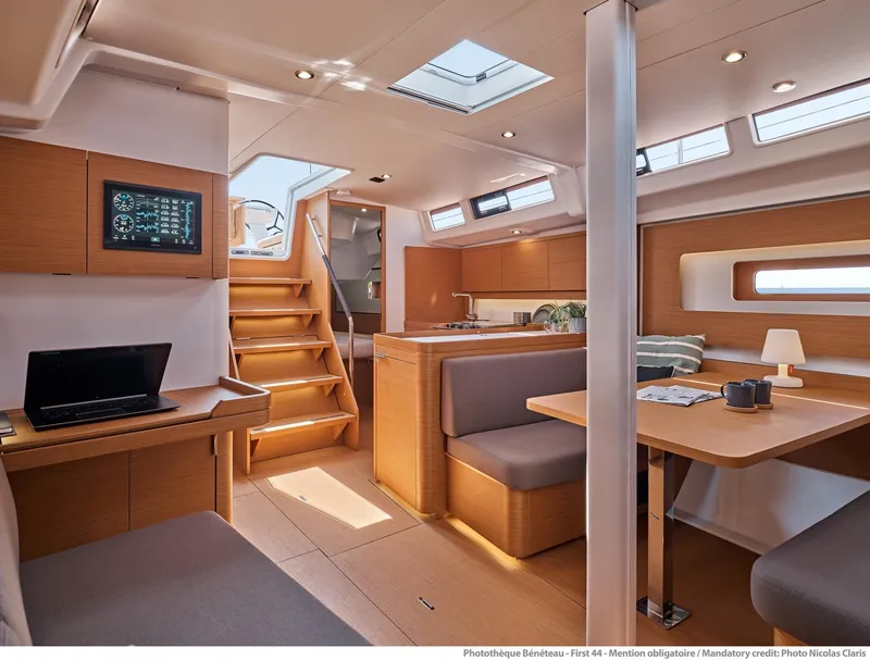 Slide: The Image of Interior of 2025 Beneteau First 44 yacht, featuring modern wood finishes and spacious seating. - 4