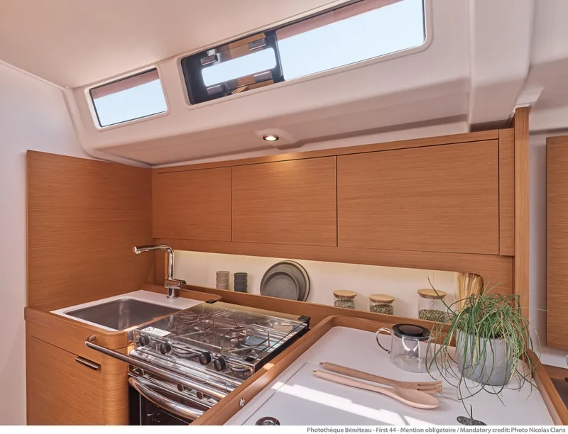 Slide: The Image of Modern kitchen in 2025 Beneteau First 44 yacht with sleek wood cabinetry. - 6