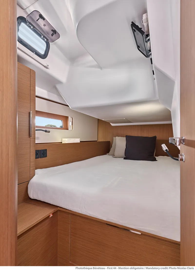 Slide: The Image of Interior cabin of 2025 Beneteau First 44 yacht, featuring a cozy bed and modern design. - 9